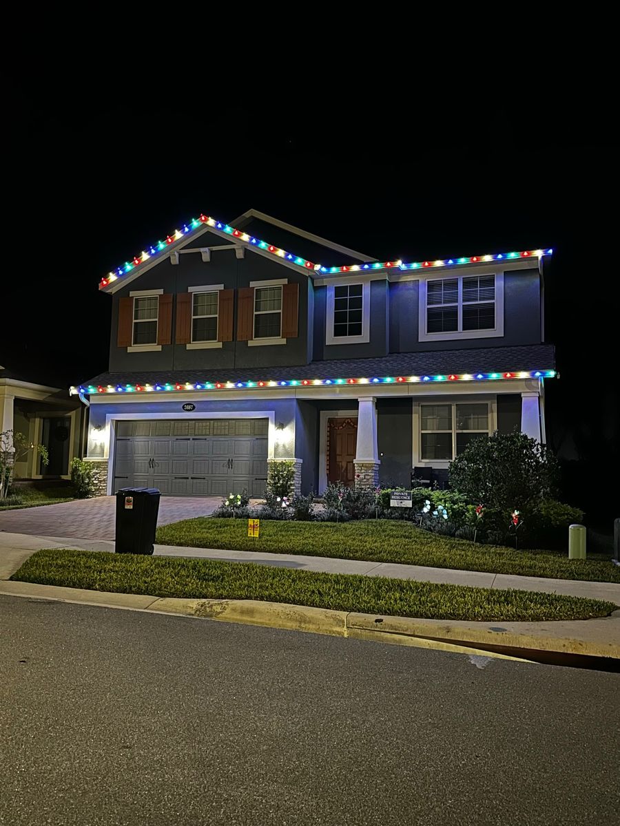 Two-story home with multicolor roofline lights
